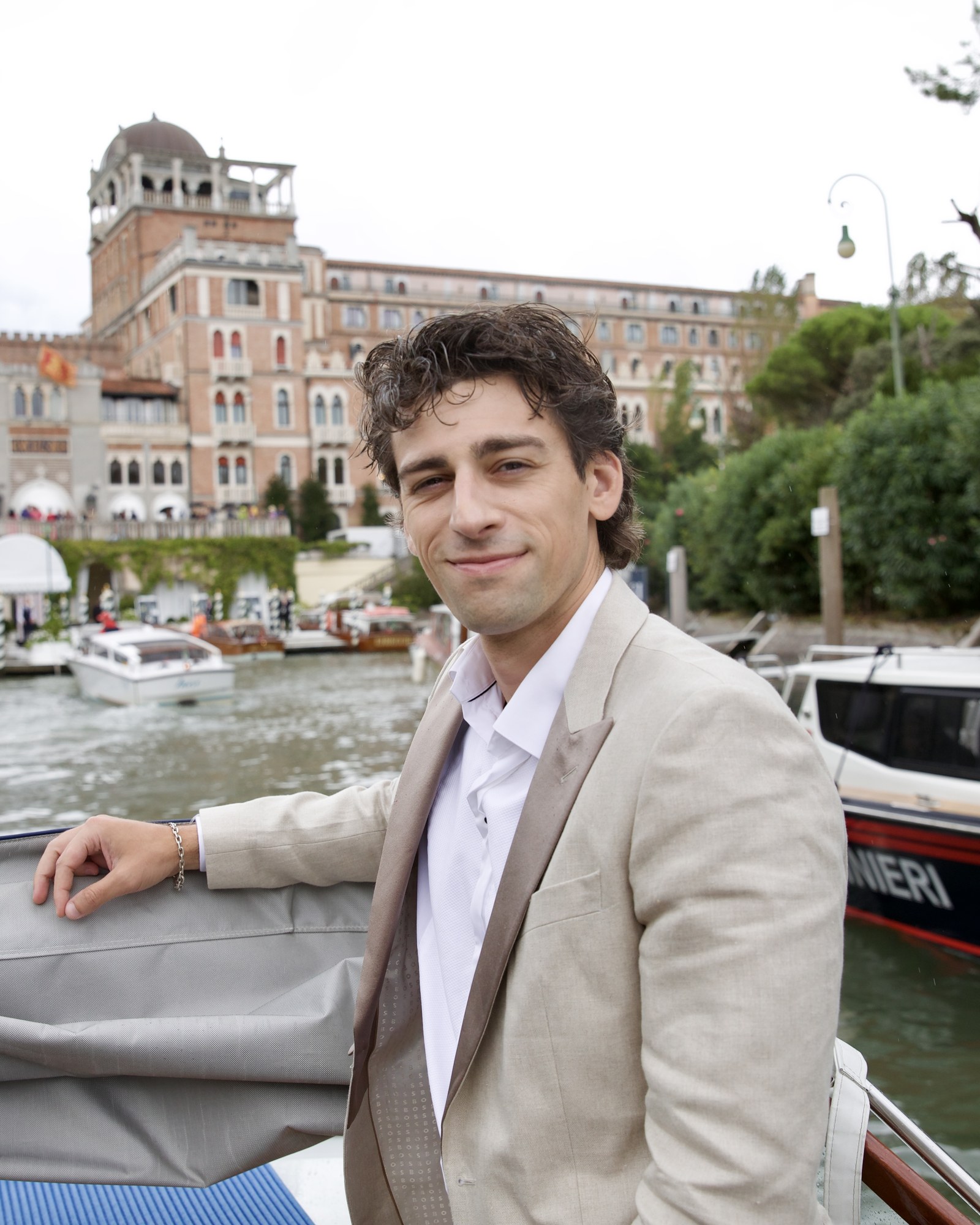 Gary Flip, tan suit, arriving by boat, Venice Film Festival